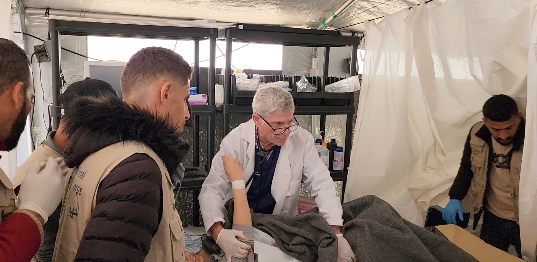 Dr. Grady examines a patient at an International Medical Corps field hospital in Gaza.